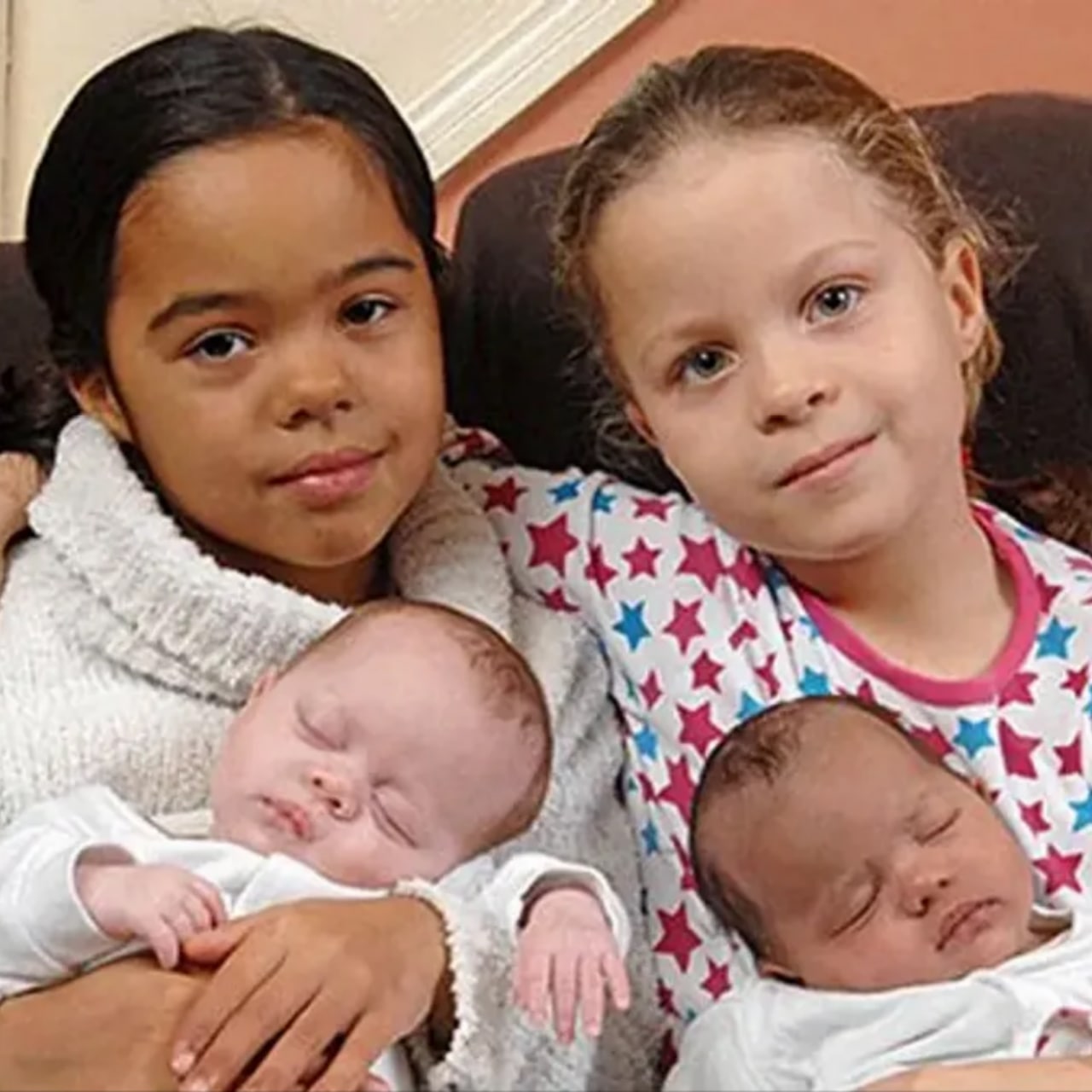 Black & white twins Hayleigh and Lauren Durrant proudly hold their new sisters — who, incredibly, are ALSO twins with different colored skin.